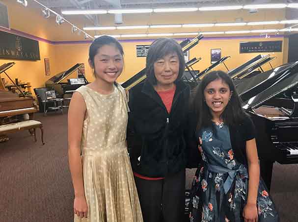 Students posing with piano teacher